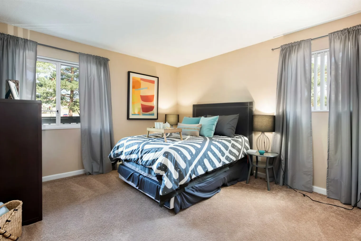 Spacious bedroom with large windows inside Oak Ridge Apartments in Aurora, CO