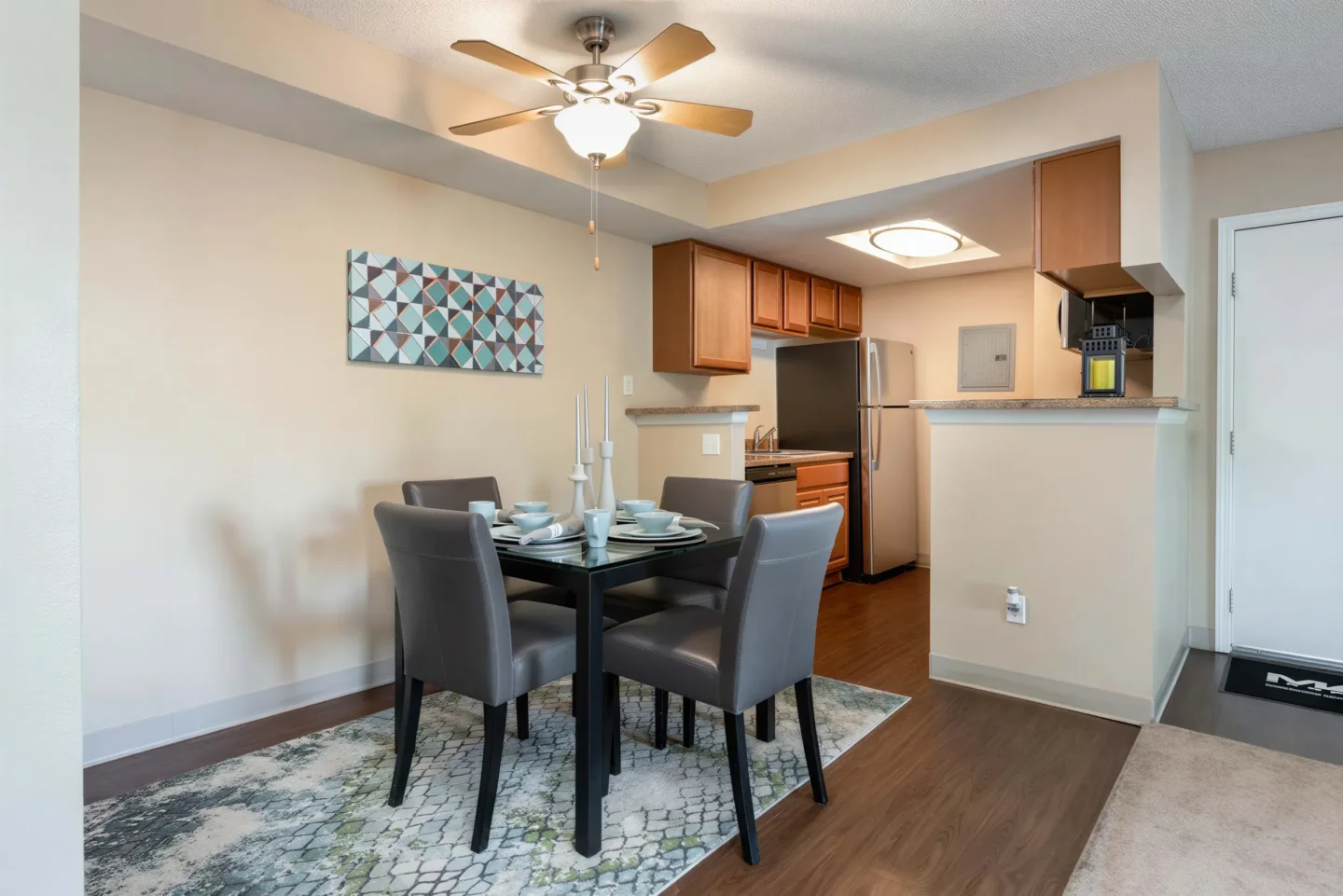 Open dining area and kitchen inside a spacious Oak Ridge Apartments home in Aurora, CO
