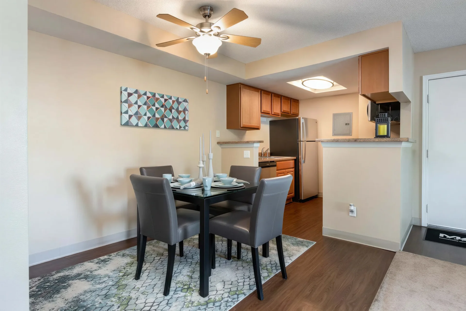 Open dining area and kitchen inside a spacious Oak Ridge Apartments home in Aurora, CO