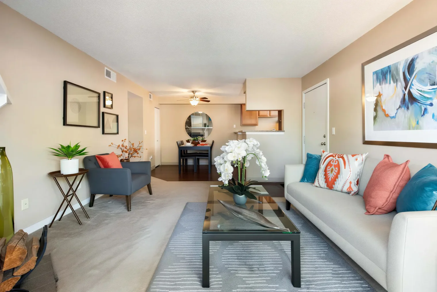 Spacious apartment living room with open dining area at Oak Ridge Apartments in Aurora, CO